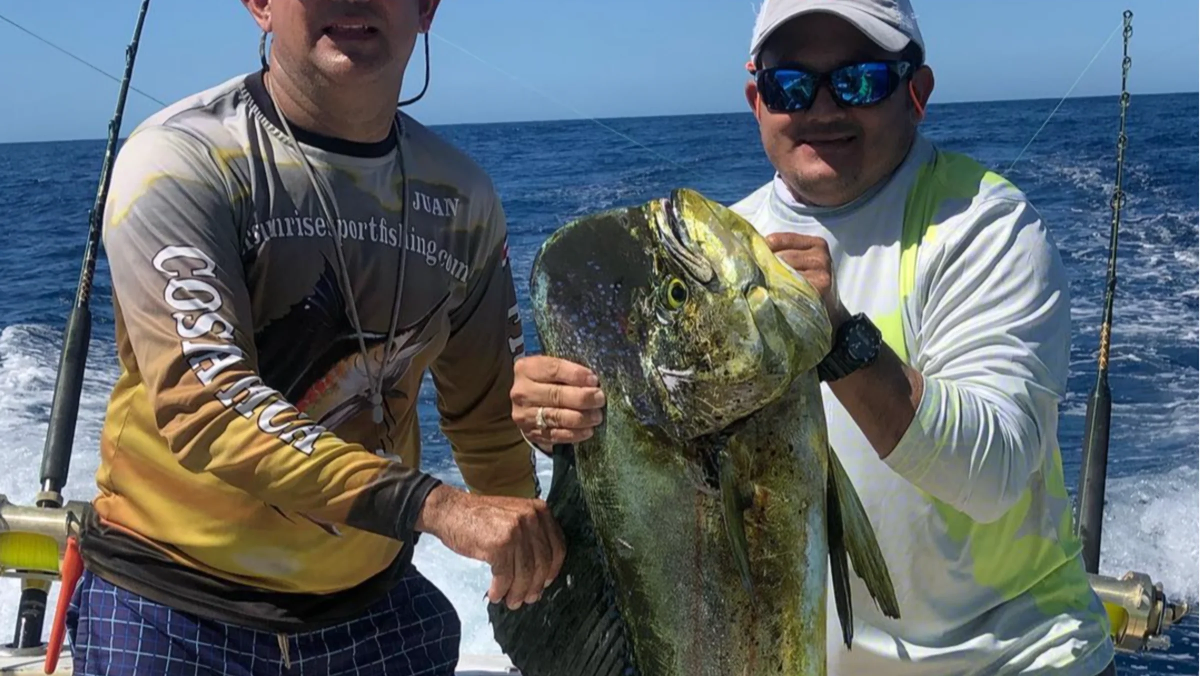 Captain Juan and his mate holding a mahi mahi caught off Guanacaste